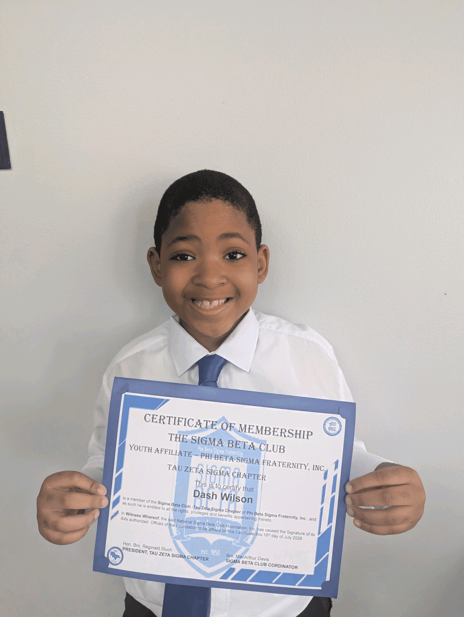 A Sigma Beta Club member with his certificate of membership