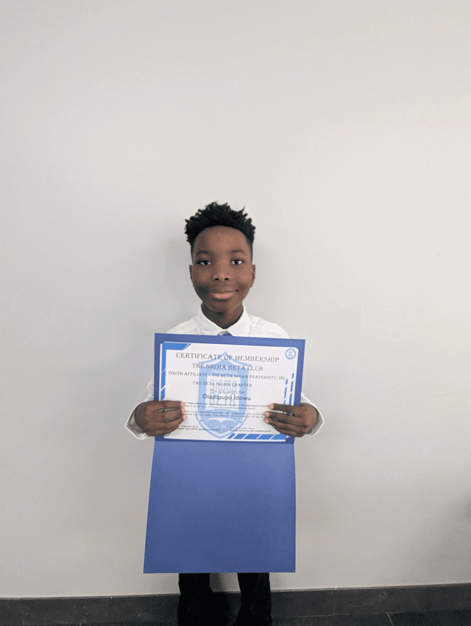 A Sigma Beta Club member with his certificate of membership