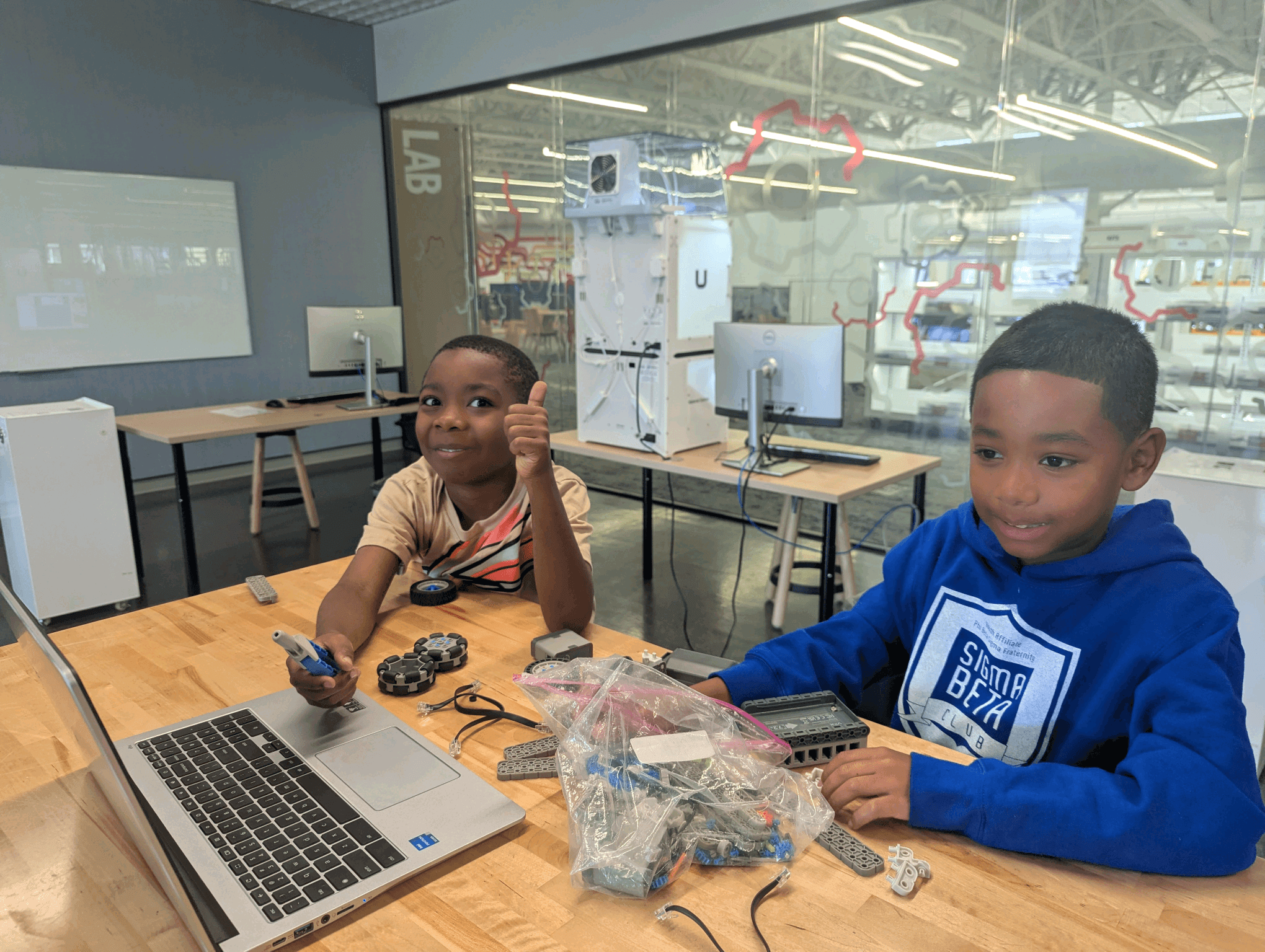 Sigma Beta Club members building a robot at STEM day