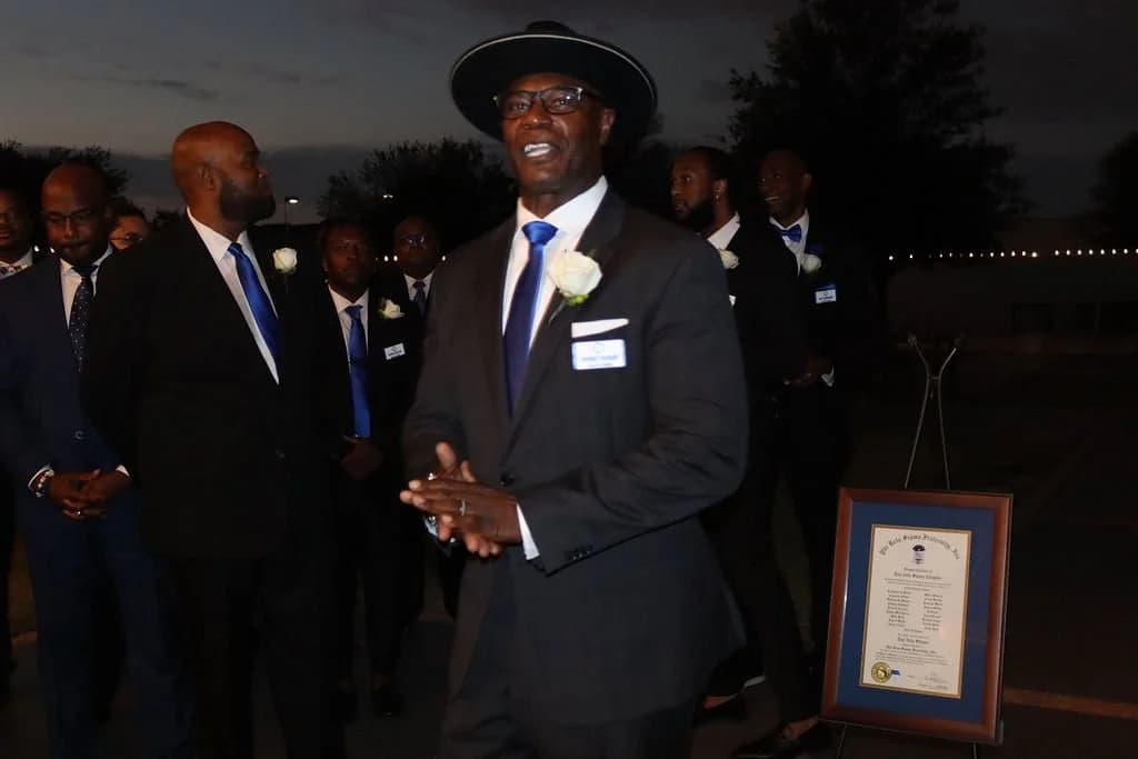 A brother addressing the chapter at an evening outdoor ceremony
